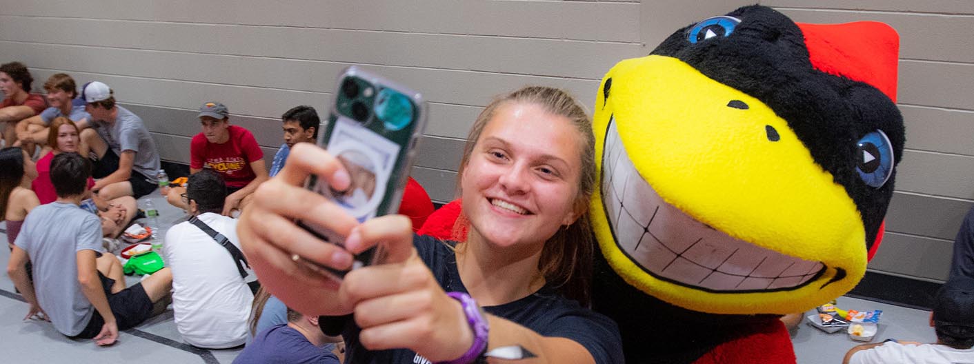 A student taking a selfie with Cy.